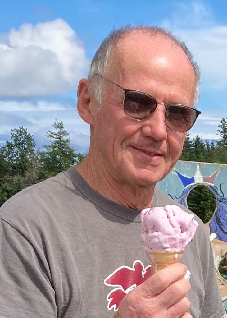 Volunteer In Education, Russ Brown holding an ice cream cone